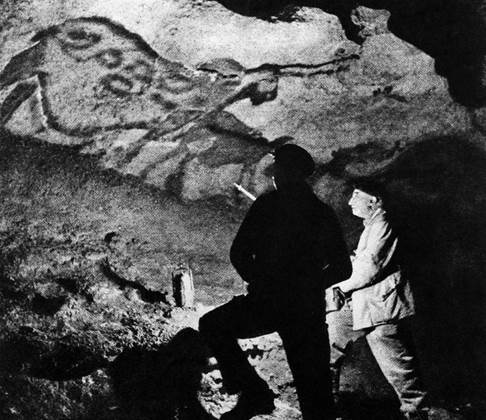 A) Abbe Breuil in Lascaux caves 

B) Representation of hut carved on cave wall at La Mouthe